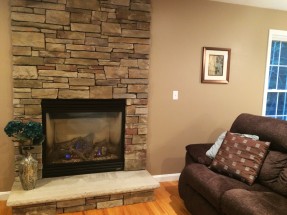 Gas fireplace with stone floor to ceiling surround